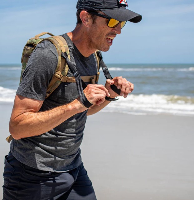 male rucking on beach with hand straps aka ruck loops aka t-rex hand straps